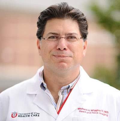 Renowned medical professional in radiology attending the SIIM Annual Meeting for networking and learning about the latest innovations in medical imaging.