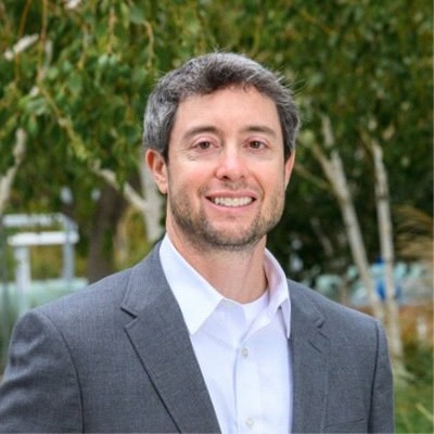 Innovative medical imaging professional attending the SIIM Annual Meeting, discussing advancements in AI and data analytics in radiology and biomedical imaging research.