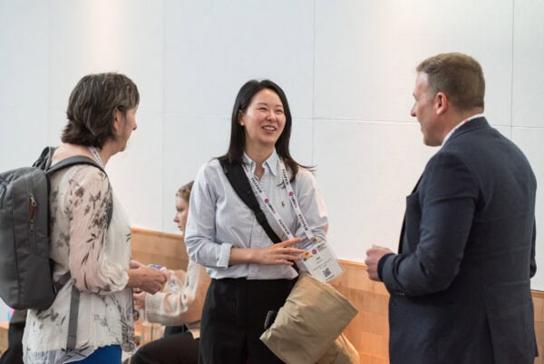 Professional networking at the SIIM Annual Meeting, featuring healthcare professionals engaging in conversations about medical imaging innovations and collaboration.