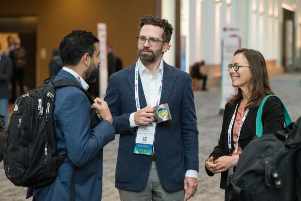 Advanced medical professionals networking at SIIM Annual Meeting, engaging in discussions about radiology innovation and technology.