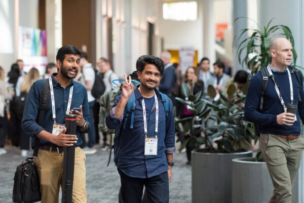 Brightly dressed attendees networking at the SIIM Annual Meeting, featuring medical imaging professionals, discussions, and conference badges in a vibrant, bustling event focused on innovations in medical imaging and informatics.