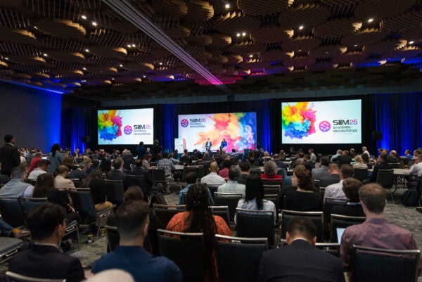 Vibrant opening session at the SIIM Annual Meeting 2023, showcasing innovative medical imaging technology and expert keynote speakers engaging healthcare professionals at the InformaticsTECH Expo.