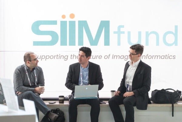 SIIM Annual Meeting, image of medical imaging professionals discussing industry innovations at the SIIM conference supporting imaging informatics and healthcare technology.