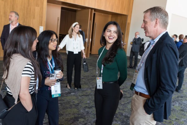 Professional networking at SIIM Annual Meeting focusing on radiology and medical imaging innovation. Attendees engage in discussions, showcasing collaboration in medical technology advancements.