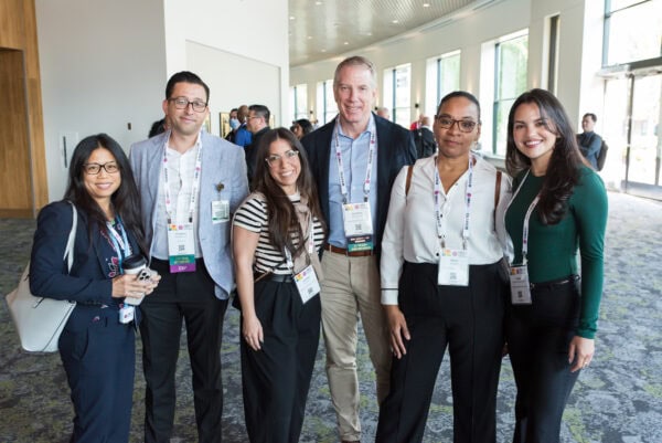 Professional healthcare attendees at the SIIM Annual Meeting networking event, showcasing collaboration among medical imaging professionals, radiologists, and IT specialists in a modern conference setting.