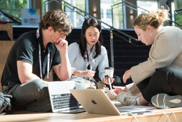 Diverse group of medical professionals collaborating during the SIIM Annual Meeting, focusing on radiology, medical imaging technology, and innovative healthcare solutions.