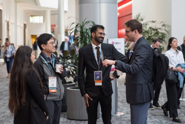 Formal networking at SIIM Annual Meeting, radiology professionals engaging and exchanging ideas in a conference setting, showcasing medical imaging, healthcare innovation, and professional development.
