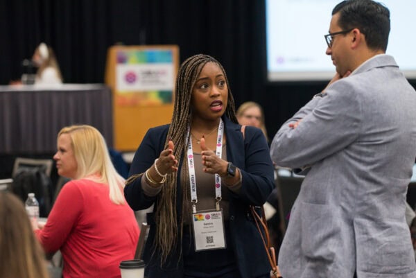 Engaging conversation at the SIIM Annual Meeting, showcasing radiology and medical imaging professionals discussing innovative healthcare technology, networking, and educational opportunities.