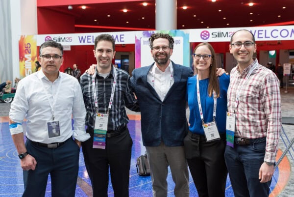 Innovative medical professionals at the SIIM Annual Meeting 2023 networking and collaborating in a vibrant conference setting.