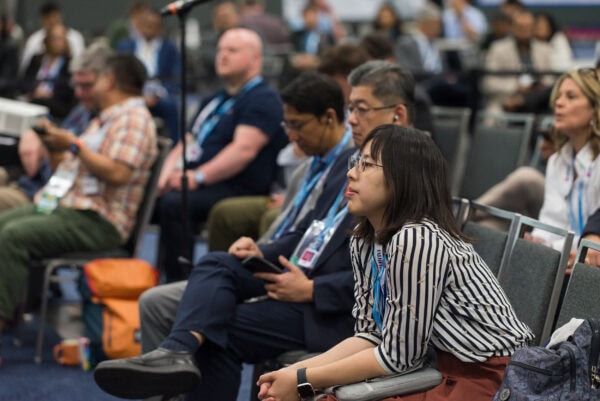 Conference attendees at the SIIM Annual Meeting listening attentively during a session, showcasing networking and professional development in medical imaging and health informatics.