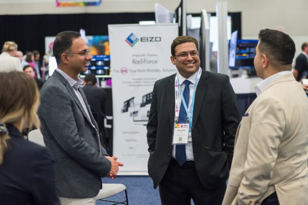 Advanced medical imaging professionals networking at SIIM Annual Meeting, showcasing innovative healthcare technology and radiology solutions, emphasizing collaboration in medical imaging industry.