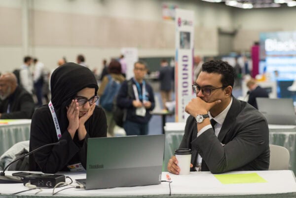 Patient and healthcare professional engaged in a serious discussion at the SIIM Annual Meeting, showcasing innovation in medical imaging and health IT.