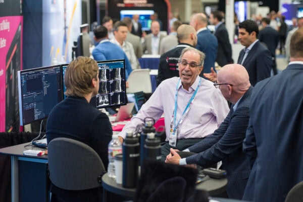 Advanced medical imaging technology discussion at SIIM Annual Meeting with radiologists and industry professionals.