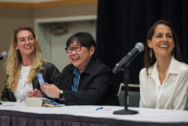 AI-generated image of diverse medical professionals smiling and engaging at the SIIM Annual Meeting, emphasizing collaboration and innovation in medical imaging and health informatics.