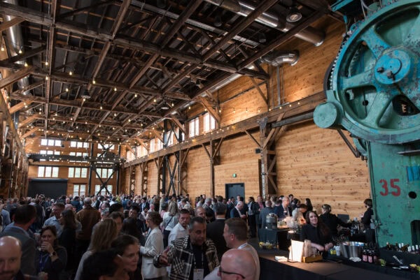 Modern industrial-style venue bustling with attendees at the SIIM Annual Meeting, showcasing networking and professional development in medical imaging and informatics.