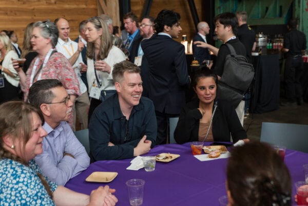 Engaged professionals networking at the SIIM Annual Meeting, showcasing collaboration and innovation in medical imaging and health informatics in a vibrant conference setting.