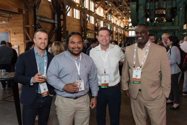 Diversity of healthcare professionals and attendees at the SIIM Annual Meeting in a rustic conference venue with warm lighting, networking, and collaborative discussions in progress.