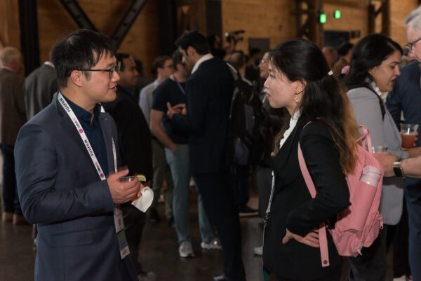 Young professional engaging in conversation at the SIIM Annual Meeting, a leading event for medical imaging informatics, digital health, and radiology innovation.