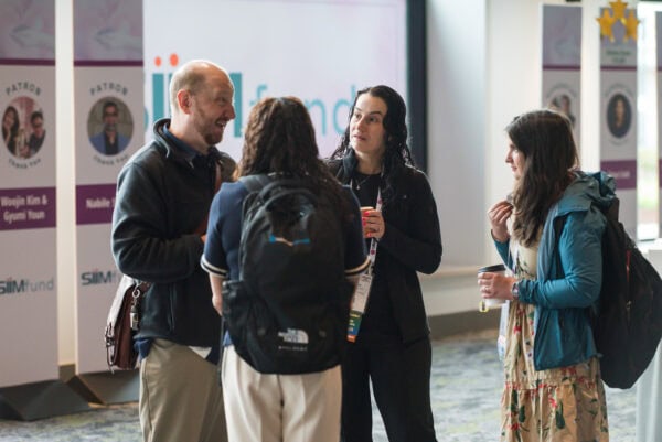 Networking at the SIIM Annual Meeting with professionals discussing medical imaging innovation and digital health technologies.