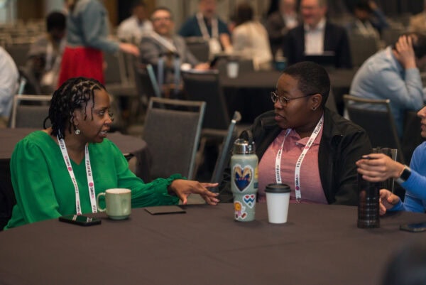 Innovative medical professionals networking at the SIIM Annual Meeting, sharing insights on AI, data science, and radiology advancements in a collaborative conference environment.