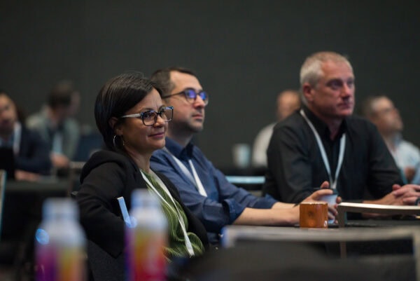 People attending SIIM Annual Meeting conference, listening attentively to presentations on medical imaging, AI in radiology, and healthcare innovations at the professional medical event.