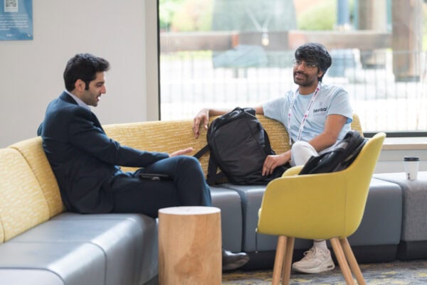 Secure medical conference networking at SIIM Annual Meeting, featuring professionals engaging in discussion, exchanging ideas, and showcasing imaging expertise in a modern lounge setting.