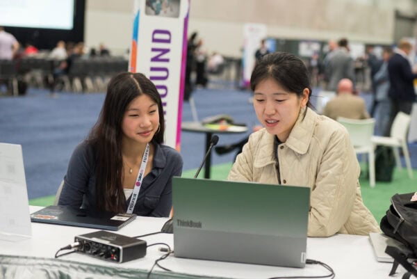Latest technology in radiology at SIIM Annual Meeting with professionals collaborating on medical imaging innovations.