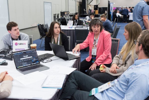 Innovative healthcare professionals collaborating at the SIIM Annual Meeting, focusing on advanced medical imaging, artificial intelligence, and imaging informatics to improve patient care and medical technology.
