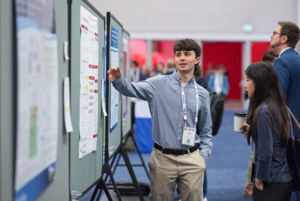 Innovative medical imaging technology showcased at SIIM Annual Meeting, featuring professionals discussing breakthrough radiology solutions and health informatics advancements.