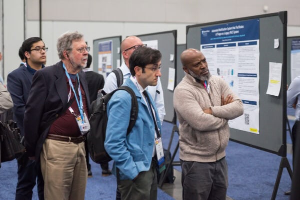 Advanced medical imaging research symposium at SIIM Annual Meeting, attendees reviewing scientific posters on imaging and AI innovations.