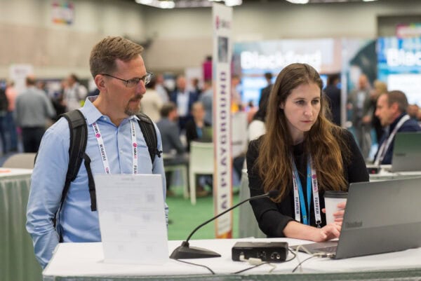 Exploring medical imaging technology at the SIIM Annual Meeting, with professionals engaging in innovative radiology solutions and digital health advancements in a bustling conference environment.