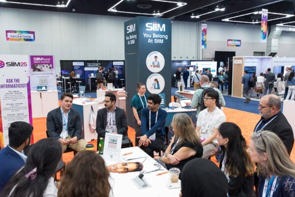 SIIM Annual Meeting exhibition hall featuring radiology and medical imaging professionals engaging in discussions and showcasing innovative healthcare technology solutions at the SIIM conference.