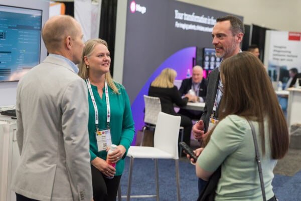 Broad medical professionals networking at SIIM Annual Meeting booth, discussing innovations in medical imaging and healthcare technology.
