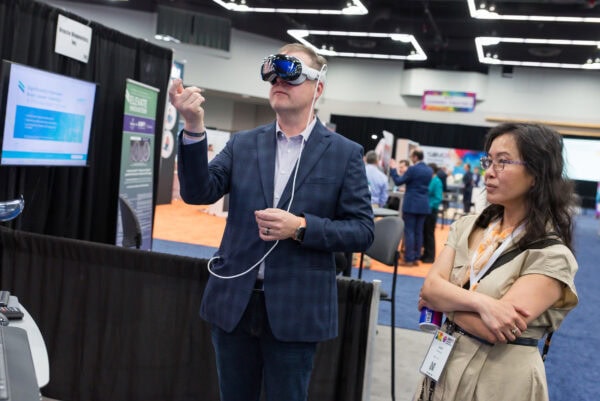 Immersed attendee exploring virtual reality technology at SIIM Annual Meeting focused on medical imaging and radiology innovation.