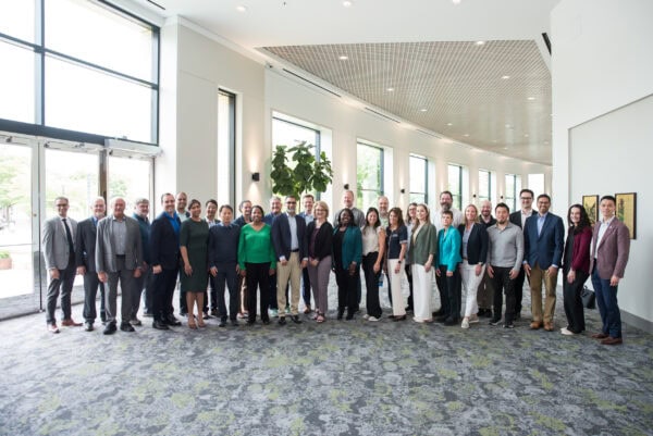 Group of healthcare professionals at the SIIM Annual Meeting conference in a modern, bright lobby showcasing medical imaging innovation and collaboration.