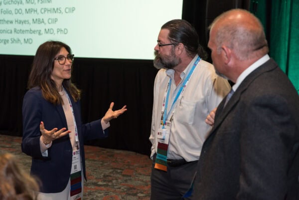 Advanced radiology conference discussion, healthcare professionals networking at SIIM Annual Meeting.