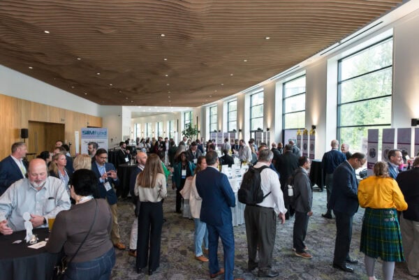 Large conference hall filled with attendees at SIIM Annual Meeting, networking near exhibitor booths and displays focused on medical imaging innovation and healthcare technology.