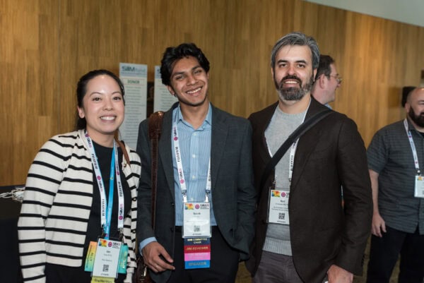 Diverse professionals smiling at the SIIM Annual Meeting, networking and sharing ideas in the medical imaging and informatics community.