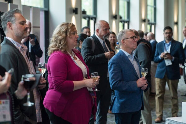 Radiology professionals attending the SIIM Annual Meeting networking and learning about innovations in medical imaging and healthcare IT at a bustling conference.