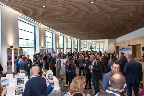 Conference networking at SIIM Annual Meeting, medical imaging professionals, health IT industry event, radiology technology expo, healthcare innovation conference in a modern event hall.
