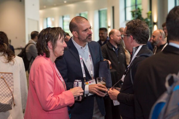 Professional networking at SIIM Annual Meeting, with attendees engaging in discussions about medical imaging innovation and healthcare technology advancements.