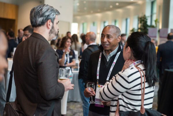 Attendees discuss advancements in medical imaging technology during the SIIM Annual Meeting conference.