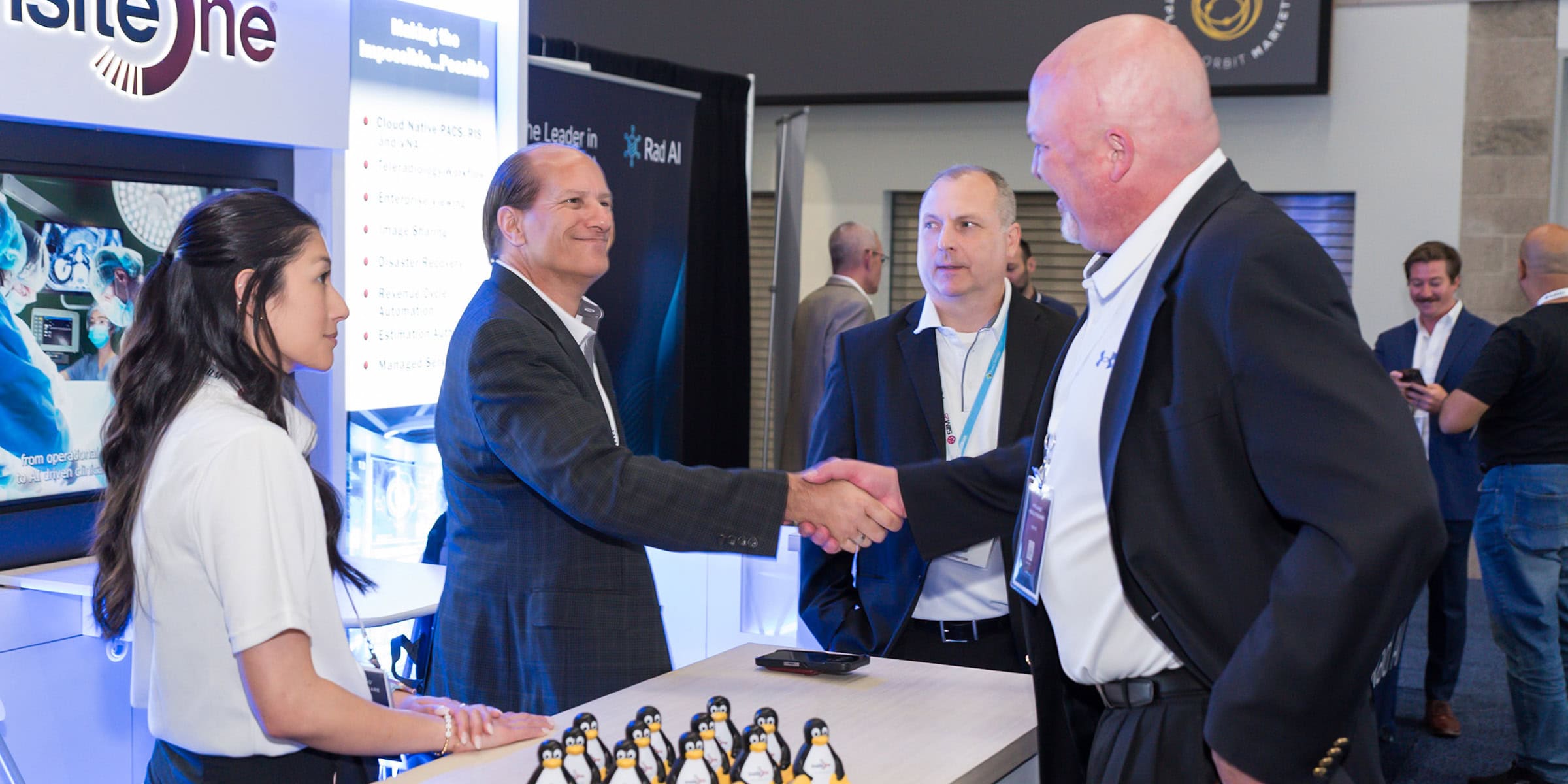 Shaking hands at SIIM Annual Meeting, healthcare professionals and industry representatives connecting at the medical imaging and informatics conference.