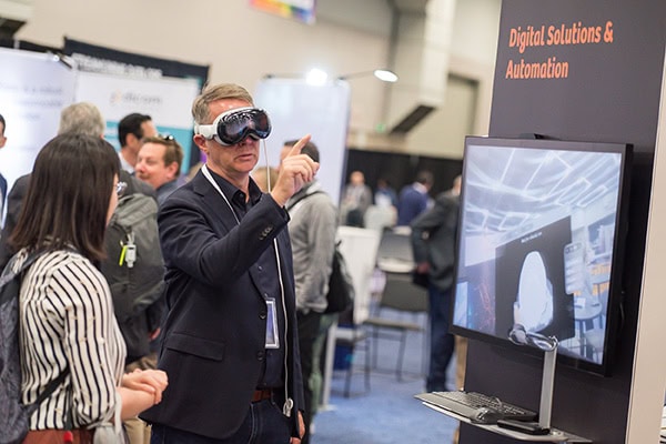 Person using VR goggles at a conference