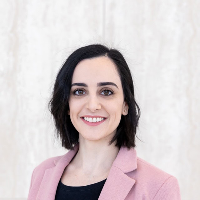Professional portrait of Ariana Familiar, PhD, smiling at the SIIM Annual Meeting, showcasing her expertise in medical imaging and informatics.