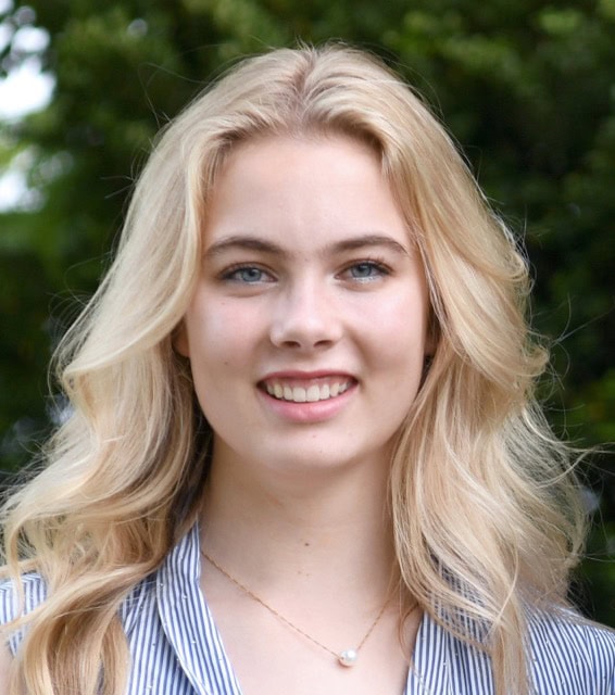 Young woman smiling outdoors at SIIM Annual Meeting, showcasing enthusiasm for medical imaging and healthcare innovation.