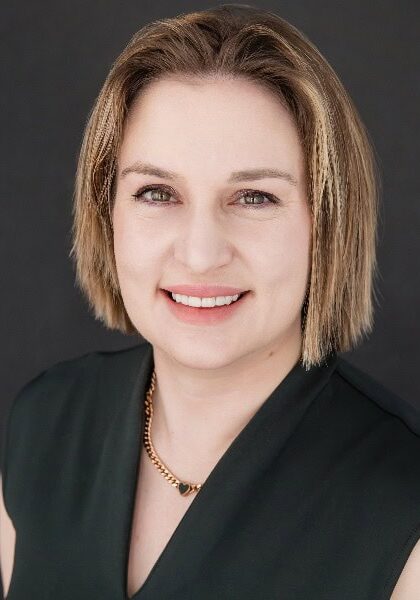 Professional woman attending the SIIM Annual Meeting 2023, engaging in medical imaging discussions and networking with industry experts.
