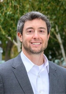 Innovative medical imaging professional attending the SIIM Annual Meeting, discussing advancements in AI and data analytics in radiology and biomedical imaging research.