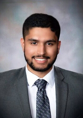 Professional headshot of Ibraheem Shaikh, MD, at the SIIM Annual Meeting, showcasing a confident smile and formal attire.