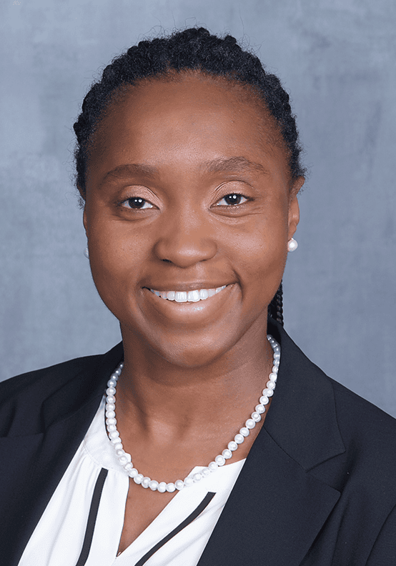 Professional woman speaker at SIIM Annual Meeting, delivering presentation on medical imaging innovations, wearing formal attire with a confident smile.